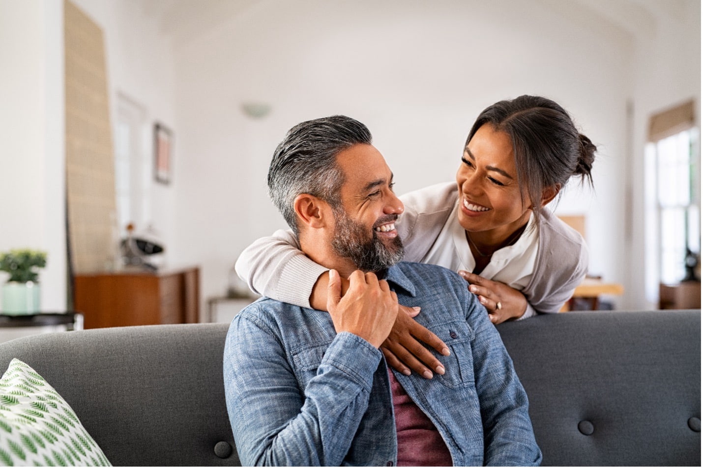 A couple smile at each other knowing their ears and earwax is healthy.